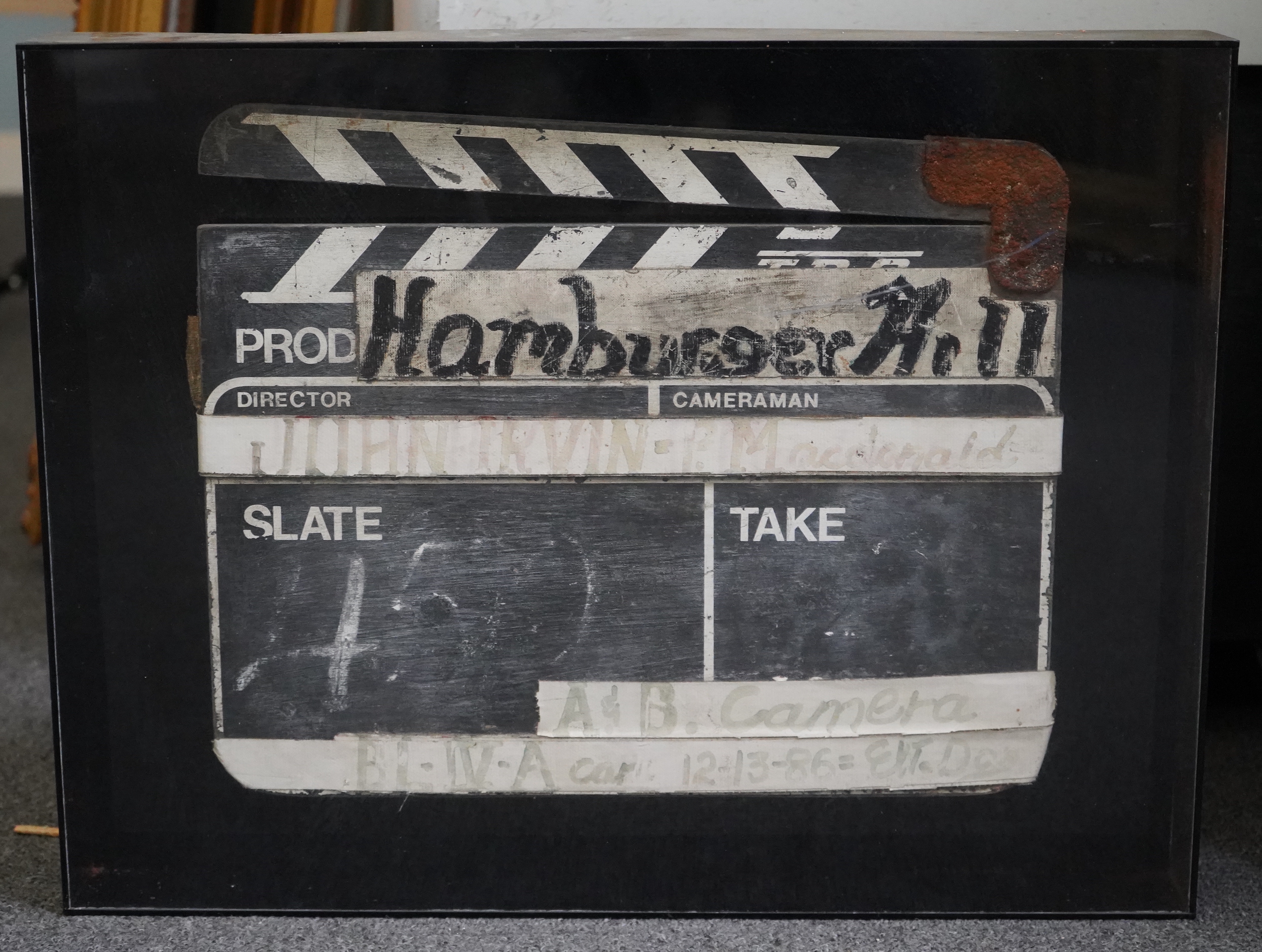 A clapperboard for A & B Camera for the film Hamburger Hill, framed and glazed.